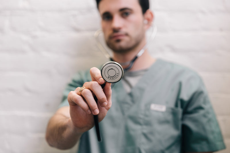 male doctor holding stethoscope