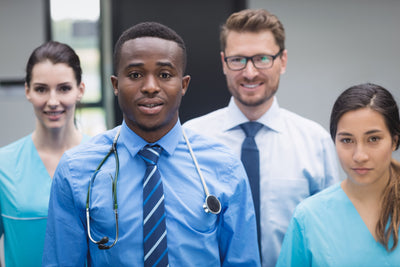 smiling medical team standing together hospital corridor